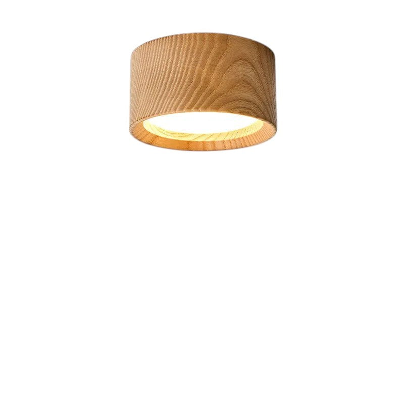 Novoora modern round LED ceiling light with a natural wood finish, casting a warm glow on a white wall.